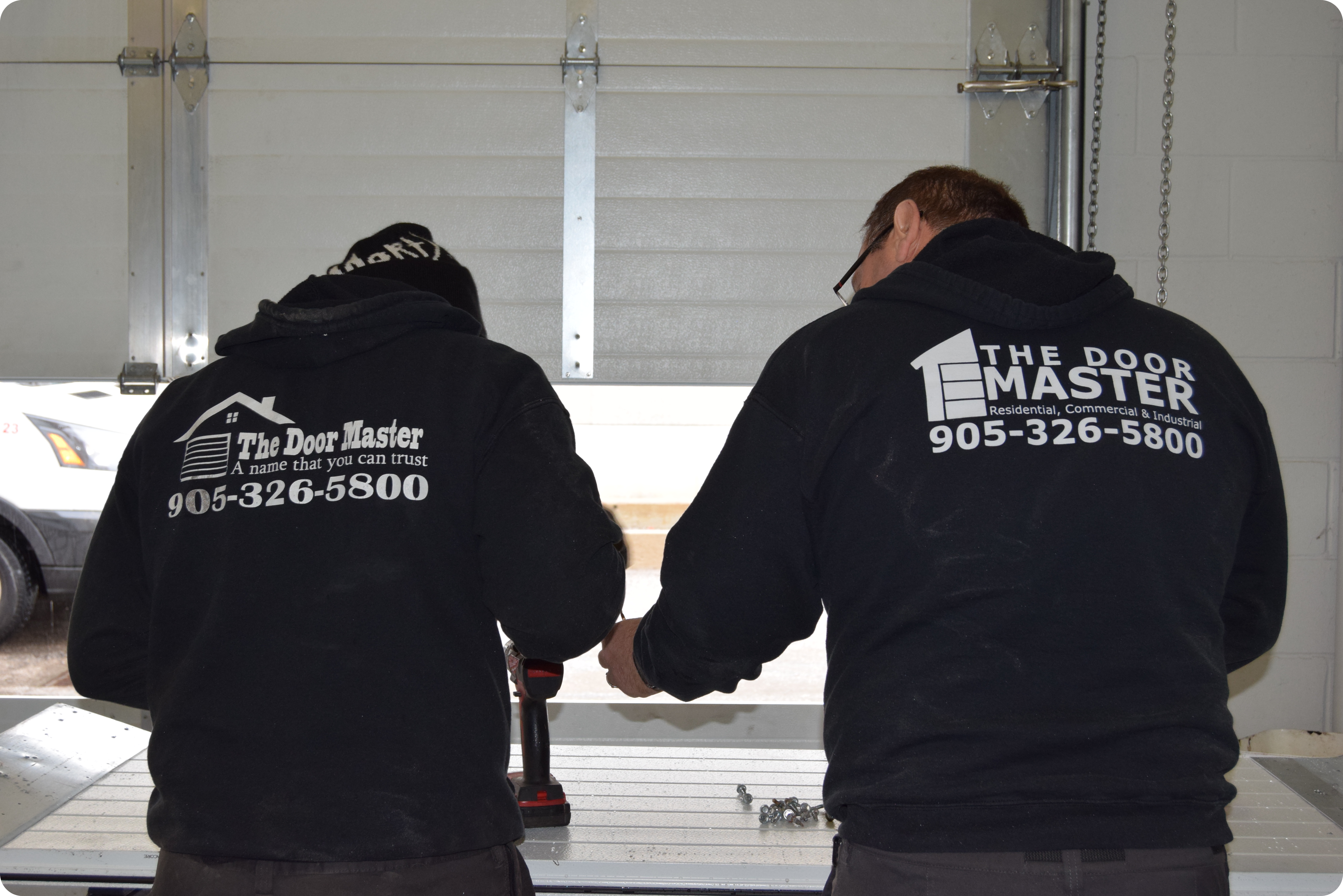 The Door Master's Team at Work, Installation of Garage Doors.