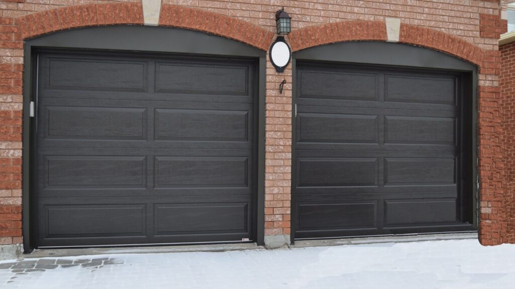 The Door Master- 2 black garage doors Raised Ranch Panel